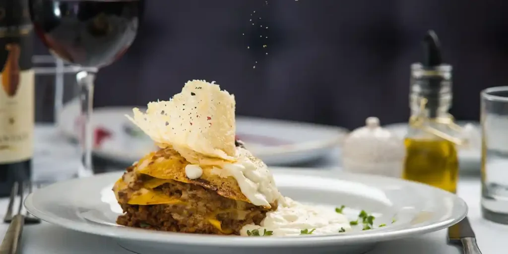 Revisited lasagna dish with parmesan cream and red wine at a campsite restaurant in Haute-Corse.
