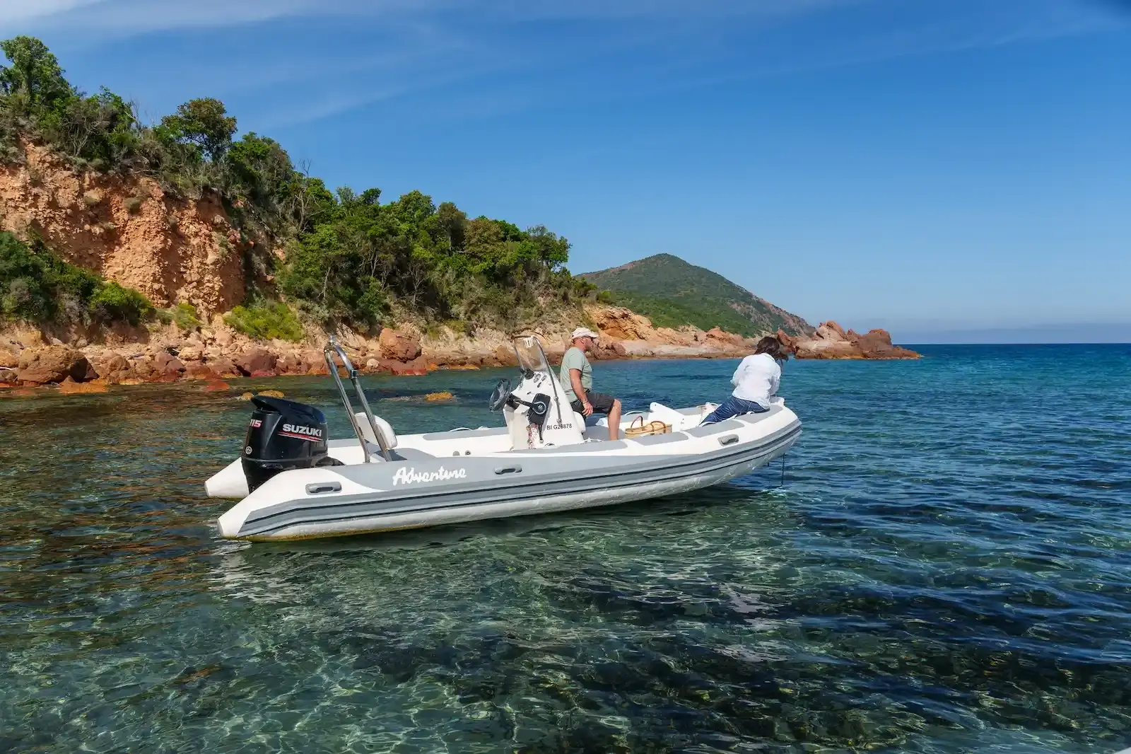 Couple profitant d'une navigation en bateau semi-rigide le long des côtes rocheuses de la Balagne.
